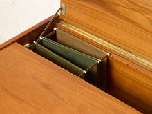 Load image into Gallery viewer, Image 16 of 22: Close-up of a wooden storage compartment with a hinged lid open, revealing hanging fabric dividers in olive green and tan.
