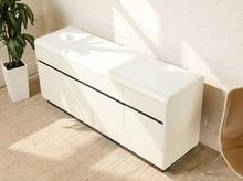 Load image into Gallery viewer, Image 3 of 18: Vintage postmodern white lacquer dresser featuring a long rectangular silhouette, softly rounded corners, asymmetrical geometric drawer fronts, recessed horizontal pulls, and a black plinth base.
