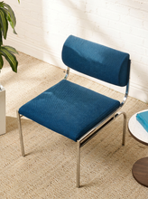 Load image into Gallery viewer, Image 3 of 14: Vintage dining chair featuring a navy blue upholstered seat, curved cylindrical padded backrest, open-back design, and slender chrome metal frame with angled legs.
