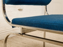 Load image into Gallery viewer, Image 12 of 14: Close-up of a mid-century modern chair with a blue textured fabric seat and back cushion, supported by a curved polished chrome metal frame.
