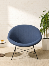 Load image into Gallery viewer, Image 3 of 17: Blue upholstered lounge chair by Claude Vassal featuring a wide rounded backrest, softly curved bowl-shaped seat, and slender black metal legs with angled supports.
