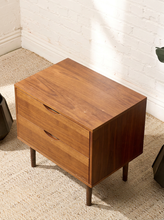 Load image into Gallery viewer, Image 6 of 16: Vintage mid-century modern wooden nightstand featuring two stacked drawers with recessed crescent-shaped pulls, warm walnut-tone wood grain, rectangular cabinet frame, and four slender tapered legs.
