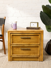 Load image into Gallery viewer, Image 4 of 21: Vintage honey oak nightstand featuring two drawers, natural wood grain, rounded faux-bamboo trim, and antique brass-tone horizontal handles, available as a pair.
