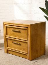 Load image into Gallery viewer, Image 8 of 21: Vintage honey oak nightstand featuring two drawers, natural wood grain, rounded faux-bamboo trim, and antique brass-tone horizontal handles, available as a pair.
