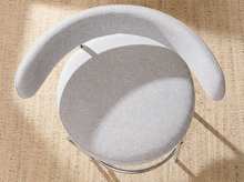 Load image into Gallery viewer, Image 9 of 18: Modern upholstered bar stool featuring a curved beige textured fabric backrest, cushioned seat, slender chrome-finished metal legs, and circular metal footrest. Sold as a pair.
