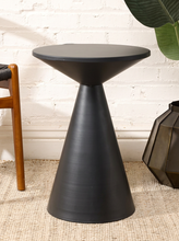 Load image into Gallery viewer, Image 4 of 14: Modern round black side table featuring a smooth circular tabletop, matte black finish, and sculptural tapered cone-shaped pedestal base with subtle surface marks.
