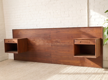 Load image into Gallery viewer, Image 4 of 22: Vintage Danish modern teak headboard featuring a long rectangular wood panel with rich reddish-brown grain and two adjustable open-box nightstands positioned near either end, compatible with queen or king beds.
