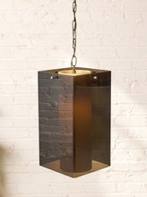 Load image into Gallery viewer, Image 1 of 24: Vintage geometric pendant light featuring a glossy dark smoked acrylic angular shade, cream-colored cylindrical light diffuser, and metal hanging chain.
