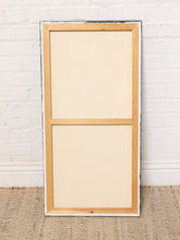 Load image into Gallery viewer, Image 8 of 8: An unpainted wooden picture frame with a natural light wood finish, standing upright against a white painted brick wall on a woven jute rug.
