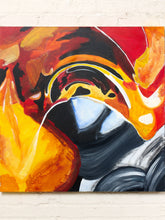 Load image into Gallery viewer, Image 2 of 8: An abstract canvas painting with bold brushstrokes in red, orange, yellow, black, white, and gray, displayed against a white brick wall.
