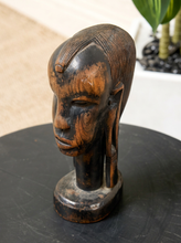 Load image into Gallery viewer, Image 3 of 13: A carved wooden African-style head bust sculpture with dark and warm brown tones, displayed on a round black surface.

