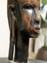 Load image into Gallery viewer, Image 10 of 13: Close-up of a carved wooden sculpture head with a dark patina and warm brown highlights, showing the side profile of a face with elongated ear and smooth neck.
