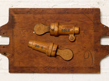 Load image into Gallery viewer, Image 2 of 9: Two vintage wooden toy or mechanical components with 'DO O' markings, displayed on a rustic wooden board against a white brick wall.
