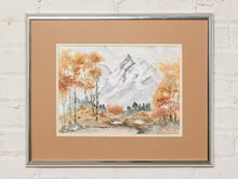 Load image into Gallery viewer, Image 1 of 8: Vintage framed mountain landscape painting featuring a dramatic rocky peak, golden yellow and burnt orange autumn trees, soft gray clouds, and earthy green foliage, surrounded by a wide gold mat and metallic frame.
