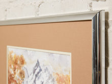 Load image into Gallery viewer, Image 6 of 8: Close-up of a framed art print with a tan textured mat, showing part of a watercolor mountain landscape with autumn foliage, set against a white brick wall.
