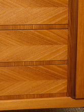 Load image into Gallery viewer, Image 15 of 27: Close-up of a wooden furniture piece showing three drawers with a herringbone pattern in a warm medium brown wood finish.
