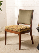 Load image into Gallery viewer, Image 2 of 15: Vintage wooden side chair featuring a square sage green upholstered backrest, cushioned floral tapestry seat with diamond lattice patterns in burgundy, blue, olive, and golden beige, and slender tapered wooden legs.
