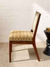 Load image into Gallery viewer, Image 4 of 15: Vintage wooden side chair featuring a square sage green upholstered backrest, cushioned floral tapestry seat with diamond lattice patterns in burgundy, blue, olive, and golden beige, and slender tapered wooden legs.
