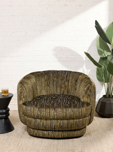 Load image into Gallery viewer, Image 3 of 16: Rowan Swivel Chair in Kenai Olive featuring olive, mustard, and charcoal abstract linear patterned upholstery, a rounded barrel backrest, curved arms, a generously cushioned seat, and a low-profile circular swivel base.
