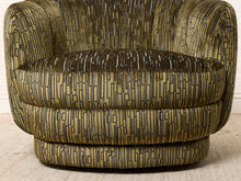 Load image into Gallery viewer, Image 13 of 16: A close-up of a modern barrel-style armchair upholstered in a textured fabric with a vertical linear pattern in olive green, beige, and black.
