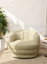 Load image into Gallery viewer, Image 3 of 16: Rowan Swivel Chair in Bay Leaf Olive featuring light olive textured upholstery, a rounded barrel backrest, softly curved arms, a generously cushioned seat, and a low-profile circular swivel base.
