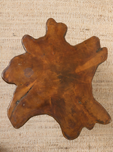 Load image into Gallery viewer, Image 4 of 16: A rustic, irregularly shaped wooden serving board or tray with a glossy finish, displayed on a textured beige burlap background.
