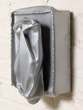 Load image into Gallery viewer, Image 3 of 13: Vintage abstract wall sculpture featuring a crumpled silver-tone metallic form with deep folds and sculptural creases, mounted on a square silver backing with raised decorative edges.
