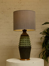 Load image into Gallery viewer, Image 2 of 17: Vintage table lamp with light gray drum shade and textured sage green and charcoal brown sculptural base
