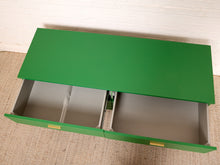 Load image into Gallery viewer, Image 15 of 15: A green metal storage cabinet with two open drawers, photographed from above against a white brick wall and beige rug.
