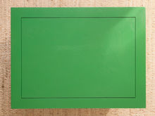 Load image into Gallery viewer, Image 10 of 21: A green rectangular mat or board with a thin black inner border, photographed from above on a beige woven fabric background.
