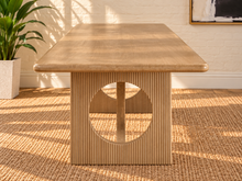 Load image into Gallery viewer, Sylvia dining table in Blonde Oak with rectangular rounded-edge top and sculptural fluted pedestal bases with circular cutouts.
