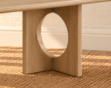 Load image into Gallery viewer, Sylvia dining table in Blonde Oak with rectangular rounded-edge top and sculptural fluted pedestal bases with circular cutouts.
