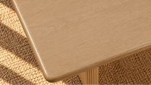 Load image into Gallery viewer, Sylvia dining table in Blonde Oak with rectangular rounded-edge top and sculptural fluted pedestal bases with circular cutouts.
