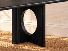 Load image into Gallery viewer, Sylvia dining table in Charcoal with rectangular rounded-edge top and sculptural black fluted pedestal bases with circular cutouts.
