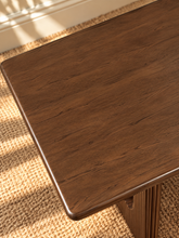 Load image into Gallery viewer, Sylvia dining table in Natural Brown Walnut with rectangular rounded-edge top and sculptural fluted pedestal bases with circular cutouts.
