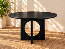 Load image into Gallery viewer, Sylvia round dining table in Charcoal with black oak veneer finish, fluted pedestal base, and distinctive circular cutouts.
