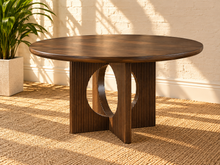 Load image into Gallery viewer, Sylvia round dining table in Natural Brown Walnut with sculptural fluted pedestal base and distinctive circular cutouts.
