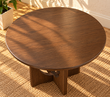 Load image into Gallery viewer, Sylvia round dining table in Natural Brown Walnut with sculptural fluted pedestal base and distinctive circular cutouts.
