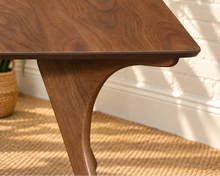 Load image into Gallery viewer, Tanner dining table in Natural Walnut with elongated rectangular top and sculpted splayed legs in a Mid-Century Modern design.
