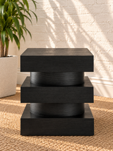 Load image into Gallery viewer, Tatum charcoal wood side table with stacked square platforms and rounded cylindrical center sections
