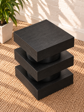 Load image into Gallery viewer, Tatum charcoal wood side table with stacked square platforms and rounded cylindrical center sections
