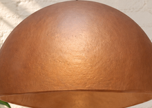 Load image into Gallery viewer, Tayla hanging lamp in terracotta with a wide dome-shaped textured fiber cement shade and black suspension cord.
