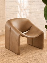Load image into Gallery viewer, Image 2 of 15: Tessa sculptural accent chair in Toasted Camel vegan leather with curved arm, open backrest, and low profile
