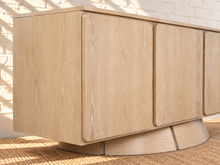 Load image into Gallery viewer, Image 5 of 5: Thera 4-Door Buffet Credenza in Blonde Oak with sculptural curved base and Art Deco detailing
