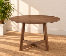 Load image into Gallery viewer, Image 2 of 4: Tori 47-inch round dining table in Natural Walnut with sculptural cross base and rounded tabletop edge
