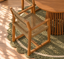 Load image into Gallery viewer, Victoria warm teak outdoor dining set with round slatted pedestal table and four woven faux rattan armchairs
