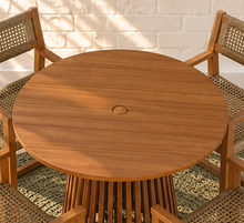 Load image into Gallery viewer, Victoria warm teak outdoor dining set with round slatted pedestal table and four woven faux rattan armchairs
