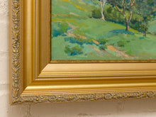 Load image into Gallery viewer, Original Felice Hrovat landscape painting with rolling green hills, mature trees and deep blue mountains in an ornate gold-tone frame.
