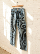 Load image into Gallery viewer, Cesar Platero hand-painted blue denim jeans with large black and gray abstract shapes, circles, lines, and expressive graphic artwork.
