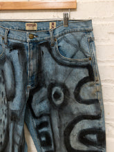 Load image into Gallery viewer, Cesar Platero hand-painted blue denim jeans with large black and gray abstract shapes, circles, lines, and expressive graphic artwork.
